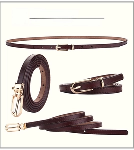 Detail of coffee brown leather skinny belt with golden pin buckle and fine stitching