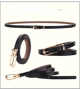 Close-up of black leather slim belt featuring a gold buckle and fine edge stitching