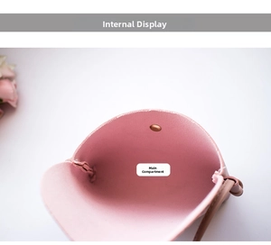 Internal display of the pink mini crossbody bag showing main pocket and snap closure