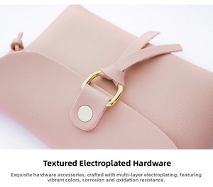 Close-up of pink lychee grain leather with electroplated gold metal ring and snap button