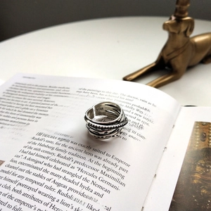 Detailed macro of vintage S925 sterling silver multi-layer wrap ring with hallmark