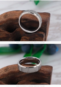 Macro detail of brushed titanium steel ring featuring vertical geometric grooves and matte finish