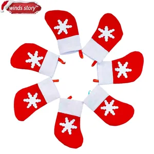 Set of 6 red Christmas stocking silverware holders with white snowflake patterns