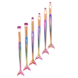 Detailed view of 6-piece mermaid makeup brushes with rainbow gradient fish scale handles