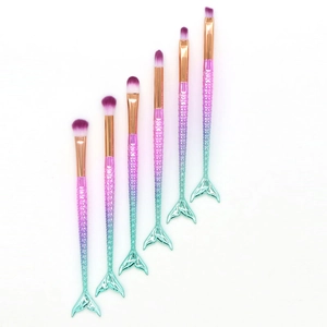 Detail of 6pcs mermaid tail makeup brushes with pink green gradient handles and soft bristles
