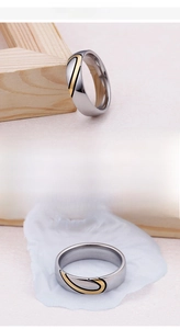Detail of 18K gold plated heart puzzle ring in polished silver finish fine steel