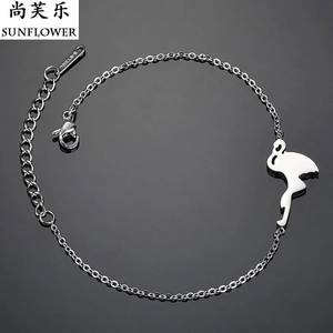 Macro shot of silver stainless steel bracelet showing lobster clasp and flamingo charm