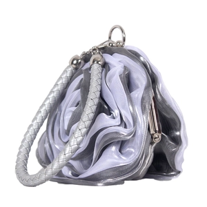 Detailed close-up of grey and purple silk rose petals on an elegant evening bag