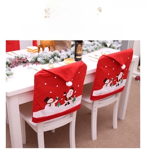 Detailed view of festive red Christmas chair covers with Santa Claus and Snowman prints