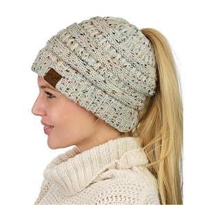 Detail of beige marl knit beanie with ponytail opening and premium C.C leather patch