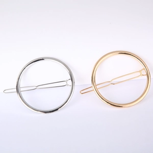 Detail of geometric circular metal hair clips in gold and silver finish for women