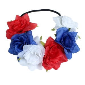 Detailed view of red, white, and blue artificial roses on a black elastic headband