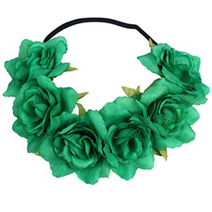 Detail of green artificial roses on a black elastic headband for festive hair styling