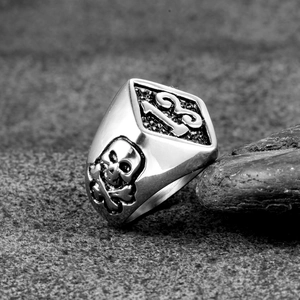 Gothic stainless steel skull ring for men with number 13 relief on a stone surface