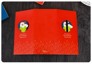 Detail of red 3D pop-up Christmas card with Santa Claus motifs and festive best wishes