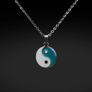 Close-up of Tai Chi Bagua pendant with color-changing enamel and stainless steel chain