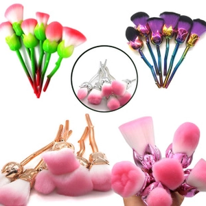 Detail view of four rose-shaped makeup brushes with colorful handles and soft synthetic bristles