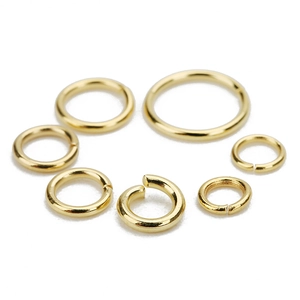 Macro detail of various sizes of golden stainless steel jump rings for DIY jewelry making