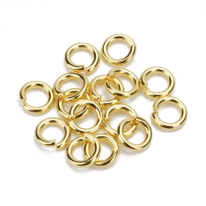 Macro shot of gold stainless steel open jump rings for DIY jewelry assembly and connection