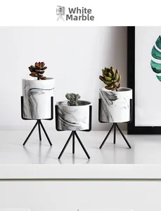 Modern white marble textured ceramic planters set with elegant black iron tripod stands