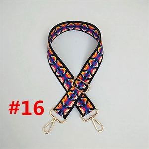 Detail of adjustable ethnic style bag strap with red blue geometric pattern and gold hooks