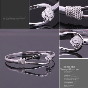Detailed views of S925 sterling silver open bangle with rose flower and twisted texture