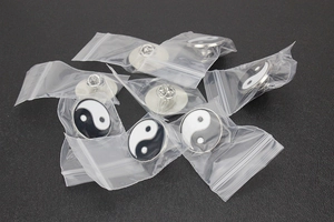 Multiple Tai Chi Yin Yang enamel pins individually packaged in transparent poly bags