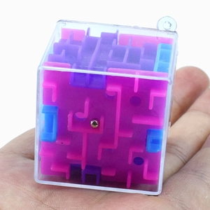 Macro view of 3D cube maze puzzle with silver rolling ball and purple tracks