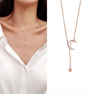 Detail of rose gold titanium steel Y-shaped necklace with moon and star pendants