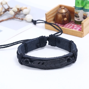 Unisex black leather feather bracelet with woven cord straps on a minimalist background