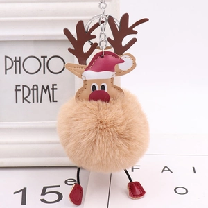 Detail of Christmas reindeer pompom keychain with red hat and silver metal ring