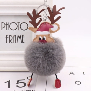 Detailed view of Christmas reindeer plush keychain with grey pompom and red boots