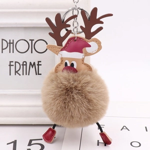 Detailed view of Christmas reindeer pompom keychain with plush ball and red PU boots