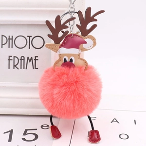Detail of pink reindeer plush pom pom keychain with red hat and silver ring