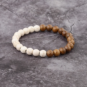 Detail of beaded bracelet showing white turquoise stones and textured brown wood beads