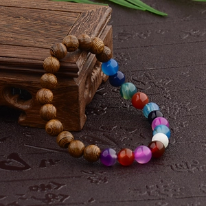 Detail of wooden beads and colorful gemstones on a handcrafted ethnic beaded bracelet