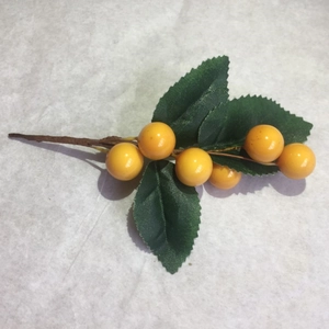 Artificial yellow berry branch with green leaves for home decor and DIY crafts