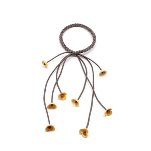 Detail of woven brown elastic hair tie with yellow floral tassels and fine fringe