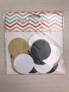 Detail of gold glitter, black, and white round paper garland in party favor packaging