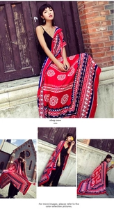 Detail of red ethnic print shawl with blue and white geometric patterns on cotton fabric
