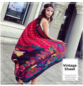 Detail of bohemian red and blue paisley patterns on an oversized linen cotton shawl