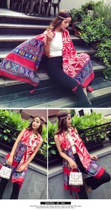 Detailed view of red ethnic cotton linen shawl with geometric patterns and red fringe