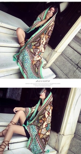 Detail of bohemian floral print scarf with tassels on vintage stone steps