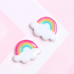 Close-up of cute resin rainbow cloud charms for DIY phone cases and craft projects