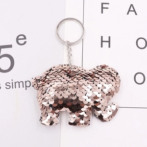 Detail of elephant-shaped keychain featuring rose gold sequins and silver metal ring
