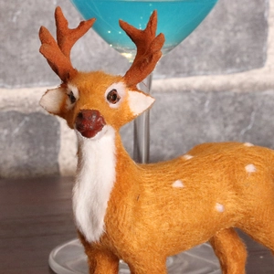 Realistic Christmas reindeer ornament with orange-brown spotted fur for festive decor