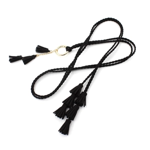 Women's black woven waist belt with golden metal rings and tassel details on white backdrop