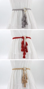 Detail of woven waist belts in three colors featuring golden rings and triple tassels