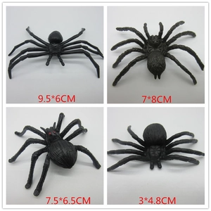 Detailed view of four black plastic spider toy variations for Halloween decorations