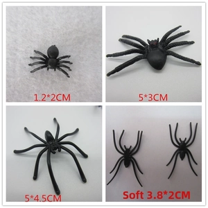 Detail view of four small soft black spider models in various sizes for Halloween decor